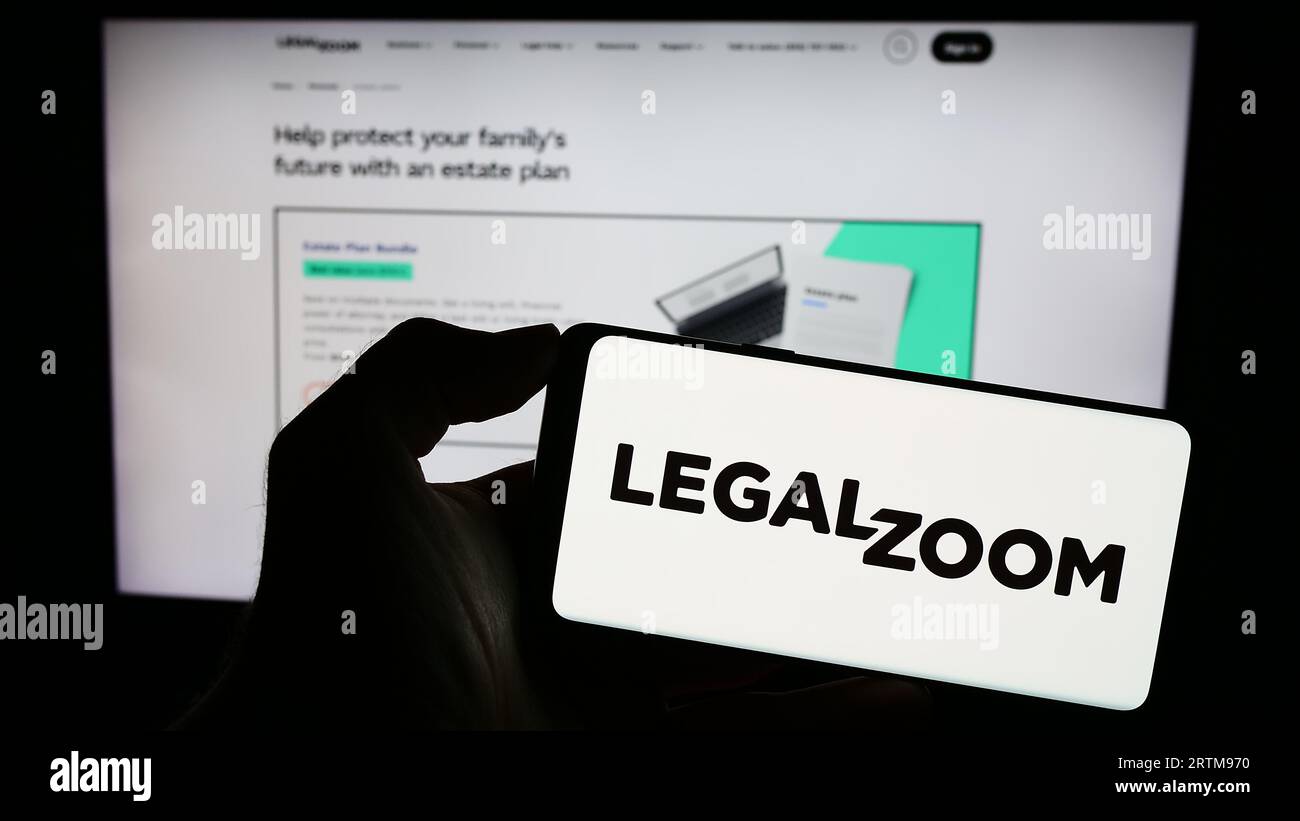 Person, die das Smartphone mit dem Logo des US-amerikanischen Rechtstechnologieunternehmens LegalZoom.com Inc. Auf dem Bildschirm vor der Website hält. Konzentrieren Sie sich auf die Telefonanzeige. Stockfoto