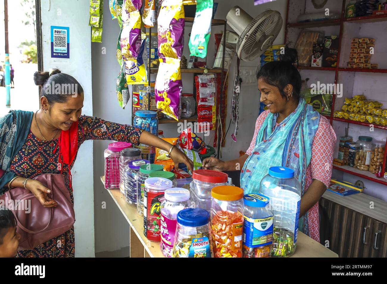 Mutter kauft Süßigkeiten für ihren Sohn in Dediapada, Gujarat, Indien Stockfoto