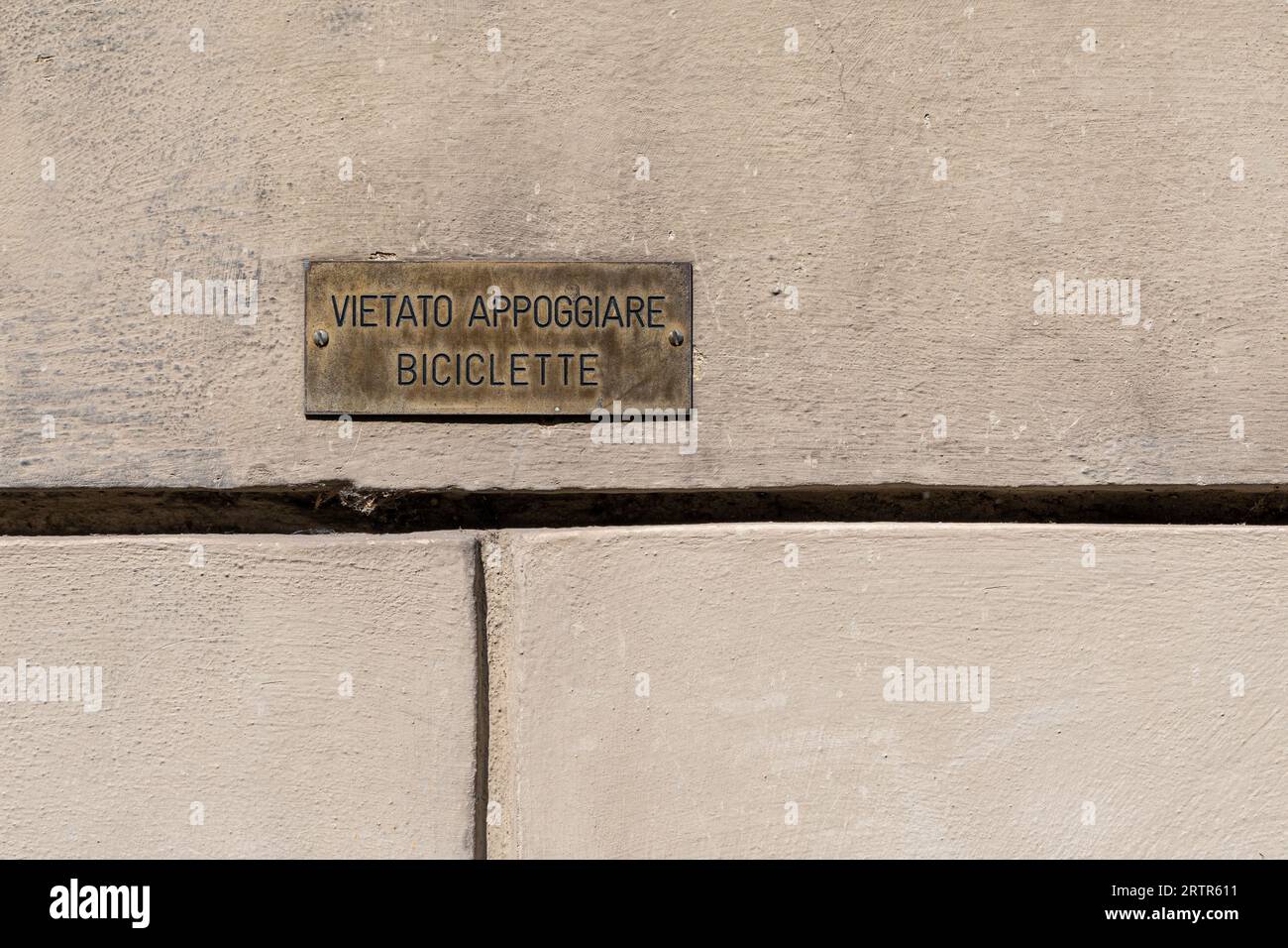 Nahaufnahme eines Metallzeichens mit der Aufschrift „Verboten, Fahrräder zu lehnen“ auf einem Wandhintergrund Stockfoto