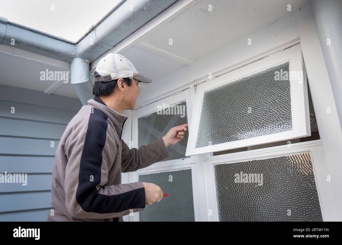 Arbeiter bereitet den Austausch des zerbrochenen Glases vor. Home Maintenance-Projekt. Stockfoto