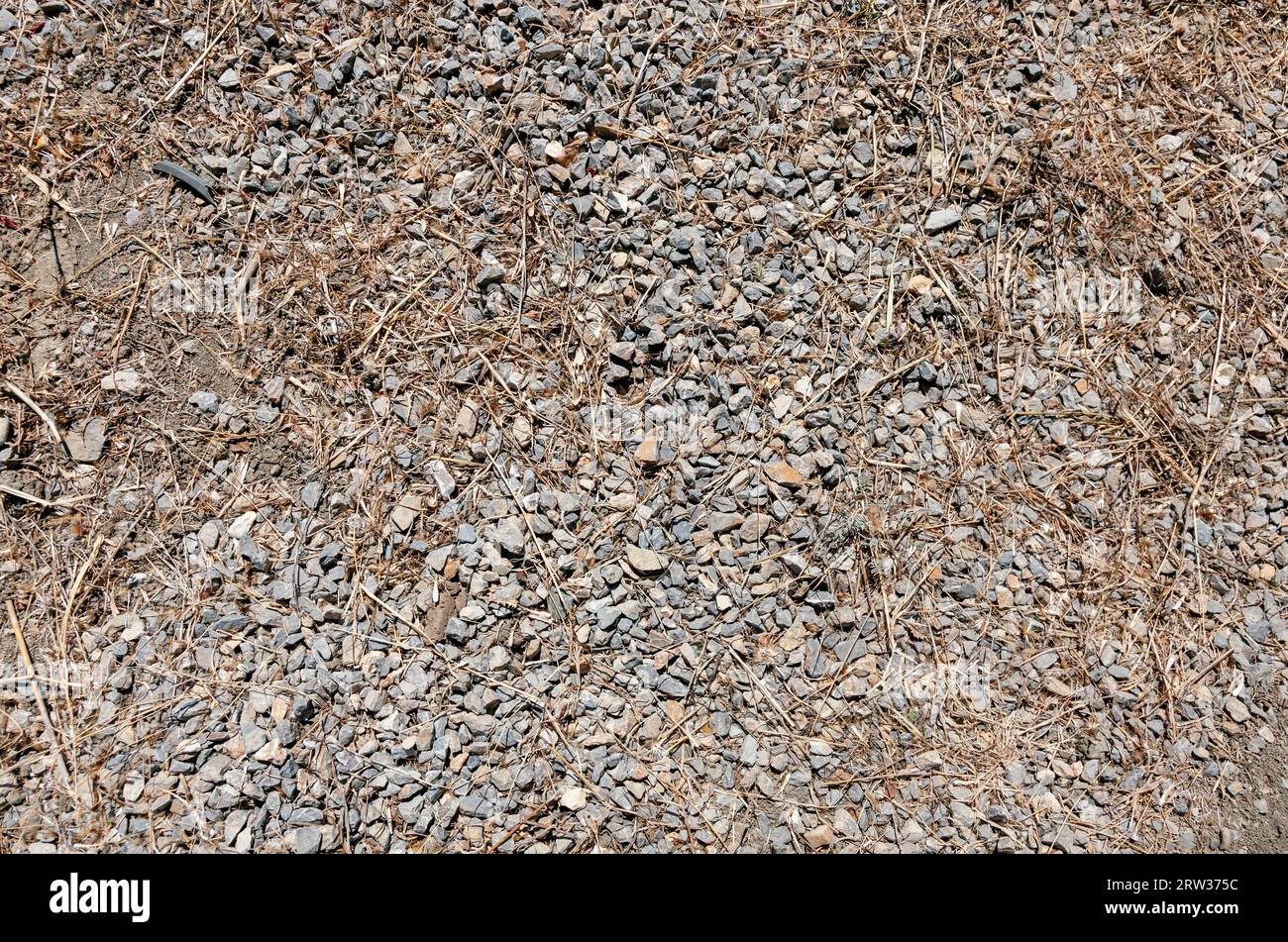 Hintergrund von getrocknetem Boden und kleinen Steinen. Ansicht von oben auf den Boden Stockfoto