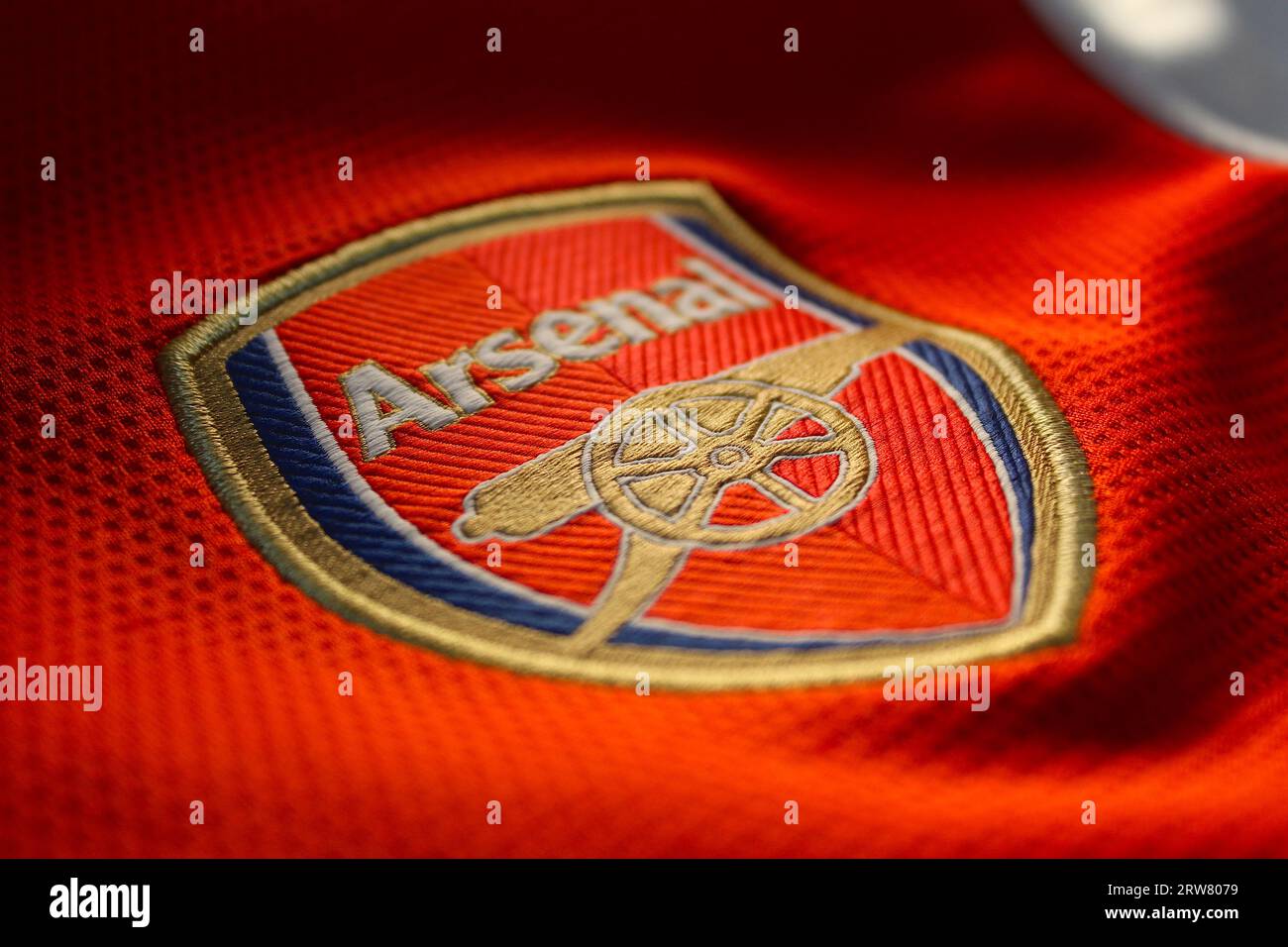 Ein Foto des rot-weißen Arsenal Football Club T-Shirts und des Abzeichens. Stockfoto