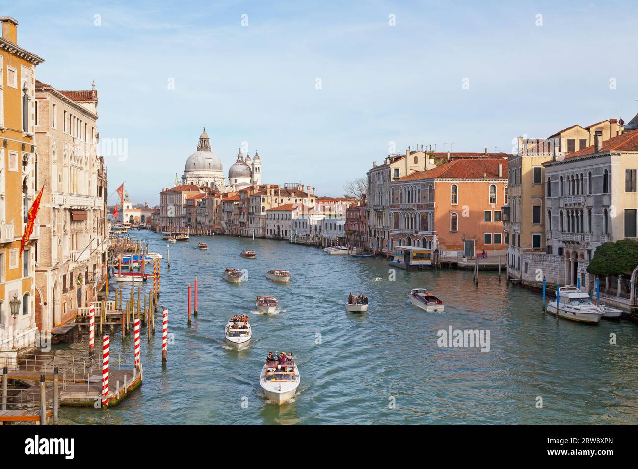 Venedig, Italien - 07. März 2019: Taxiboote auf dem Canale Grande fahren an berühmten Sehenswürdigkeiten vorbei, wie der Basilika Santa Maria della Salute, der Sina C. Stockfoto