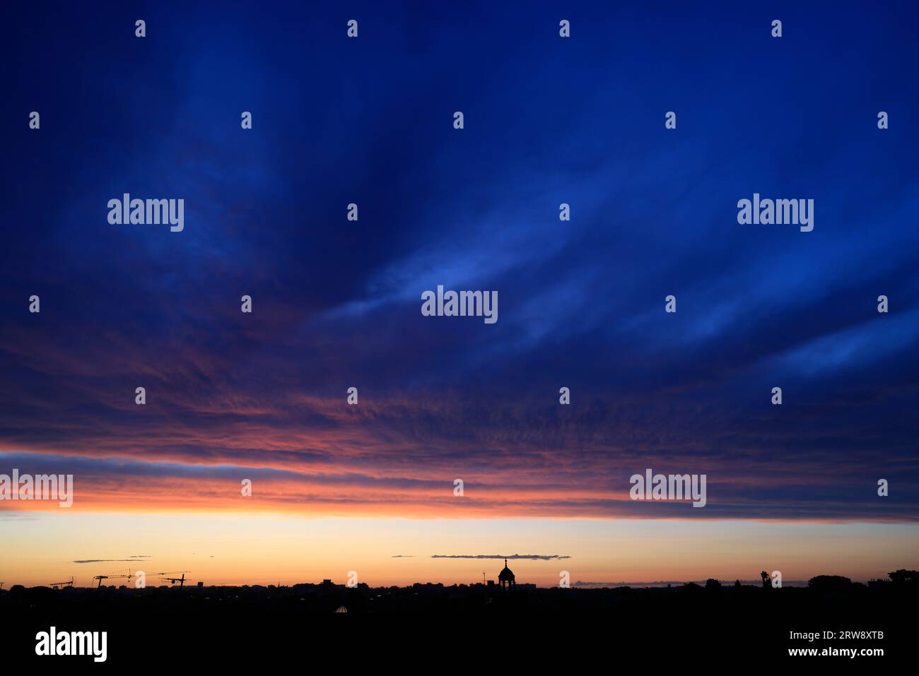 Untergehende Sonne, Sonnenuntergang, mit bunten und bedrohlichen Wolken am Himmel über der Stadt. Bordeaux, Gironde, Frankreich, Europa. Foto: Hugo Martin. Stockfoto