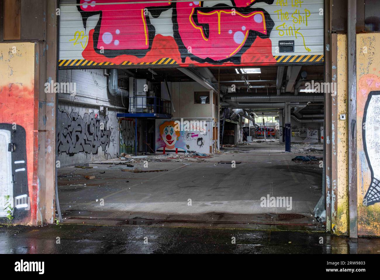 Vandalistisches, verlassenes Industriebau hinter halb offener Laderampe in Paimio, Finnland Stockfoto