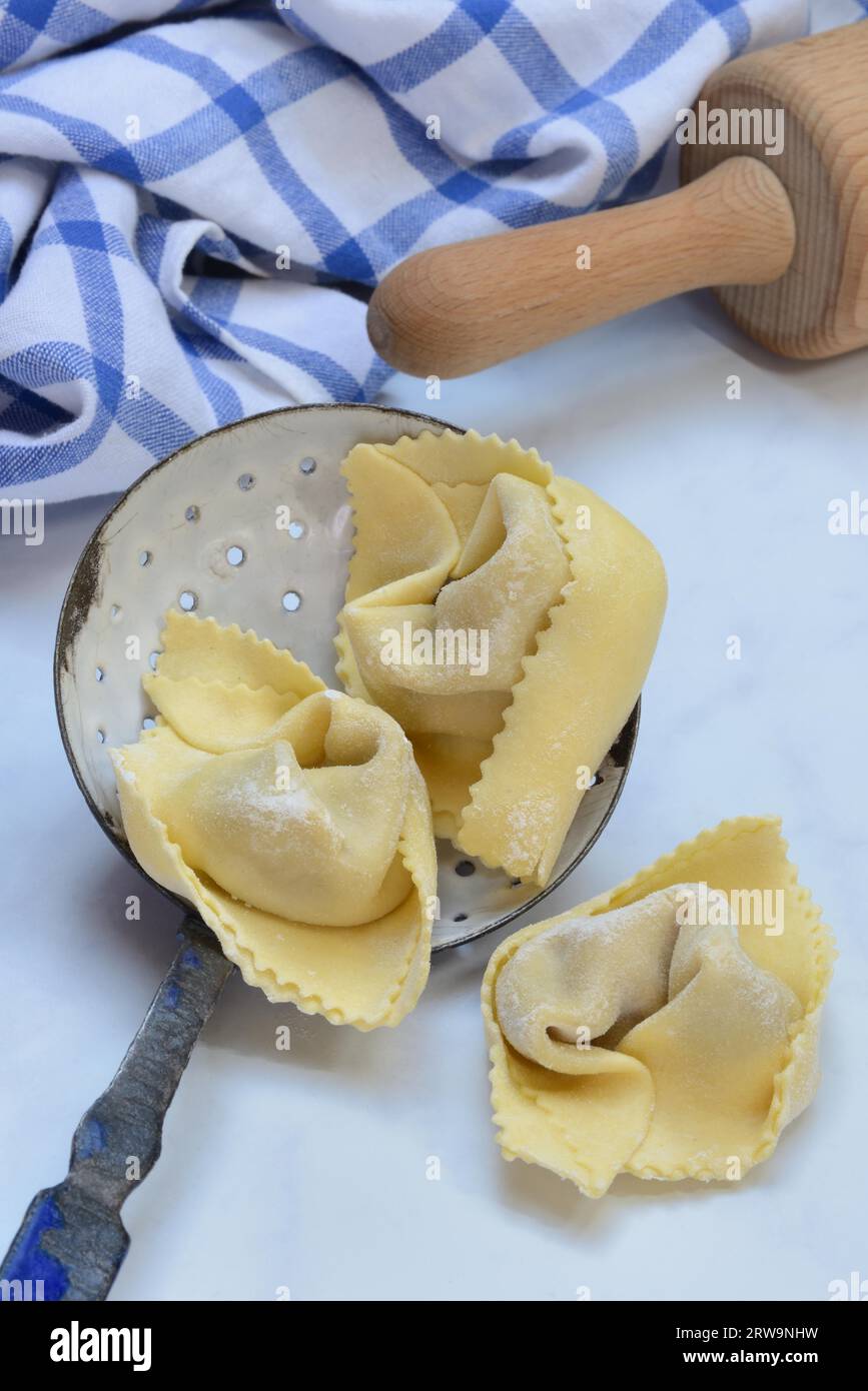 Frisch zubereitete Tortelloni in einer Siebkelle, Pasta Stockfoto
