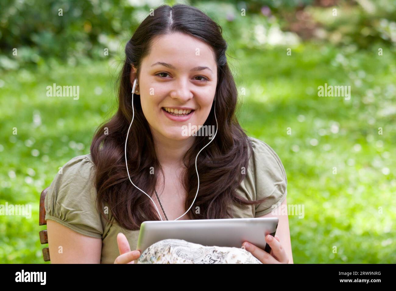 Junge Frau mit Tablet-PC im Garten, junge Frau mit Tablet-PC im Garten Stockfoto