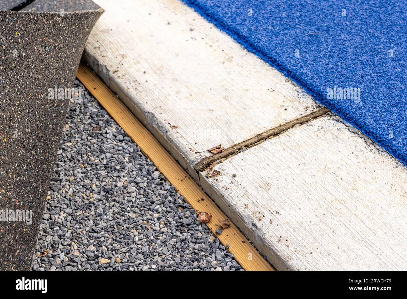 Betonkrone neben einer Laufschiene und Holznagler für Bretter zur Befestigung von Kunstrasen Stockfoto
