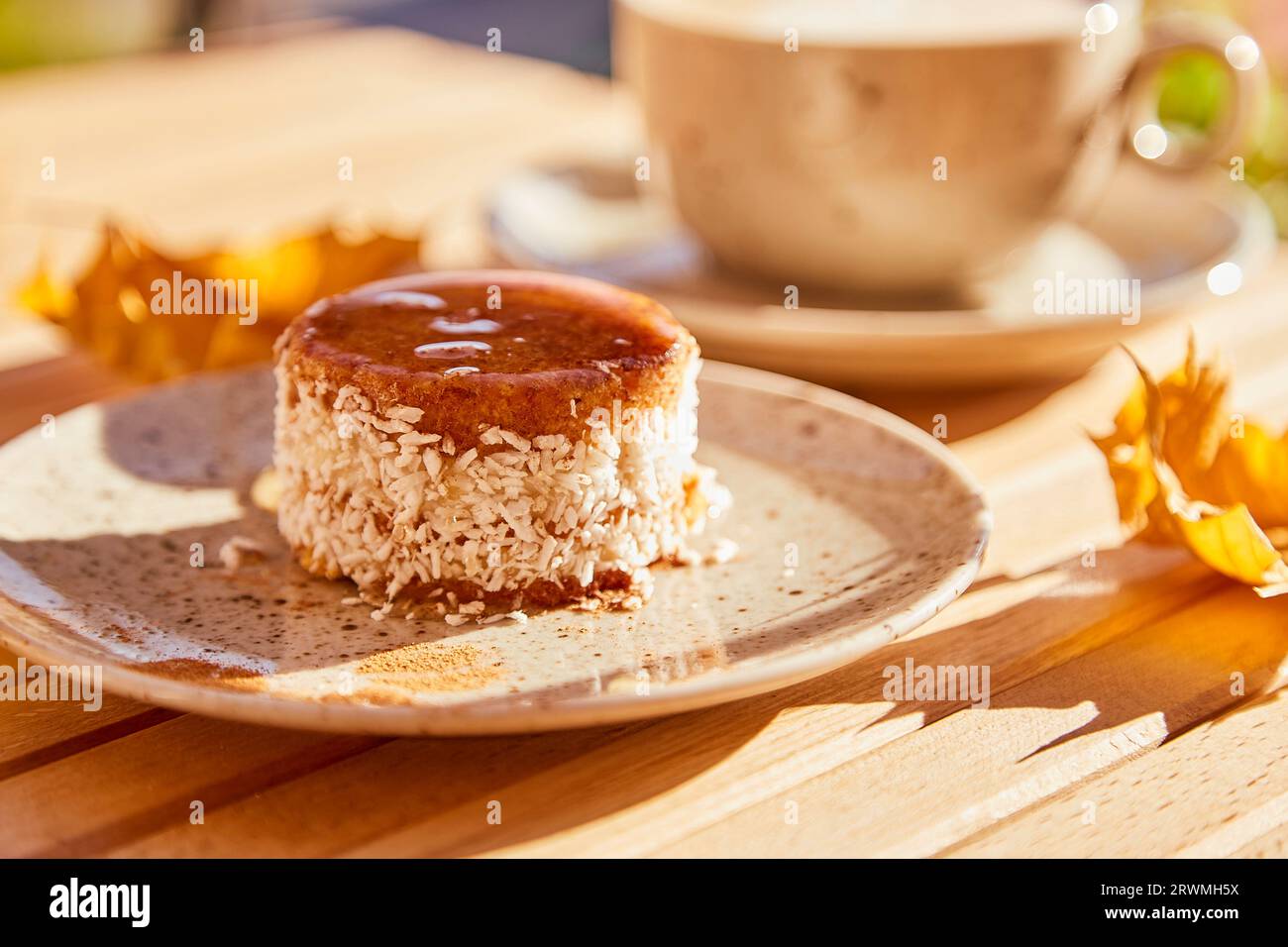 Vegetarischer Karottenkuchen mit Agavensirup. Kein Backen und kein Zuckerdessert mit einer Tasse Kaffee. Gesundes Frühstück draußen. Stockfoto