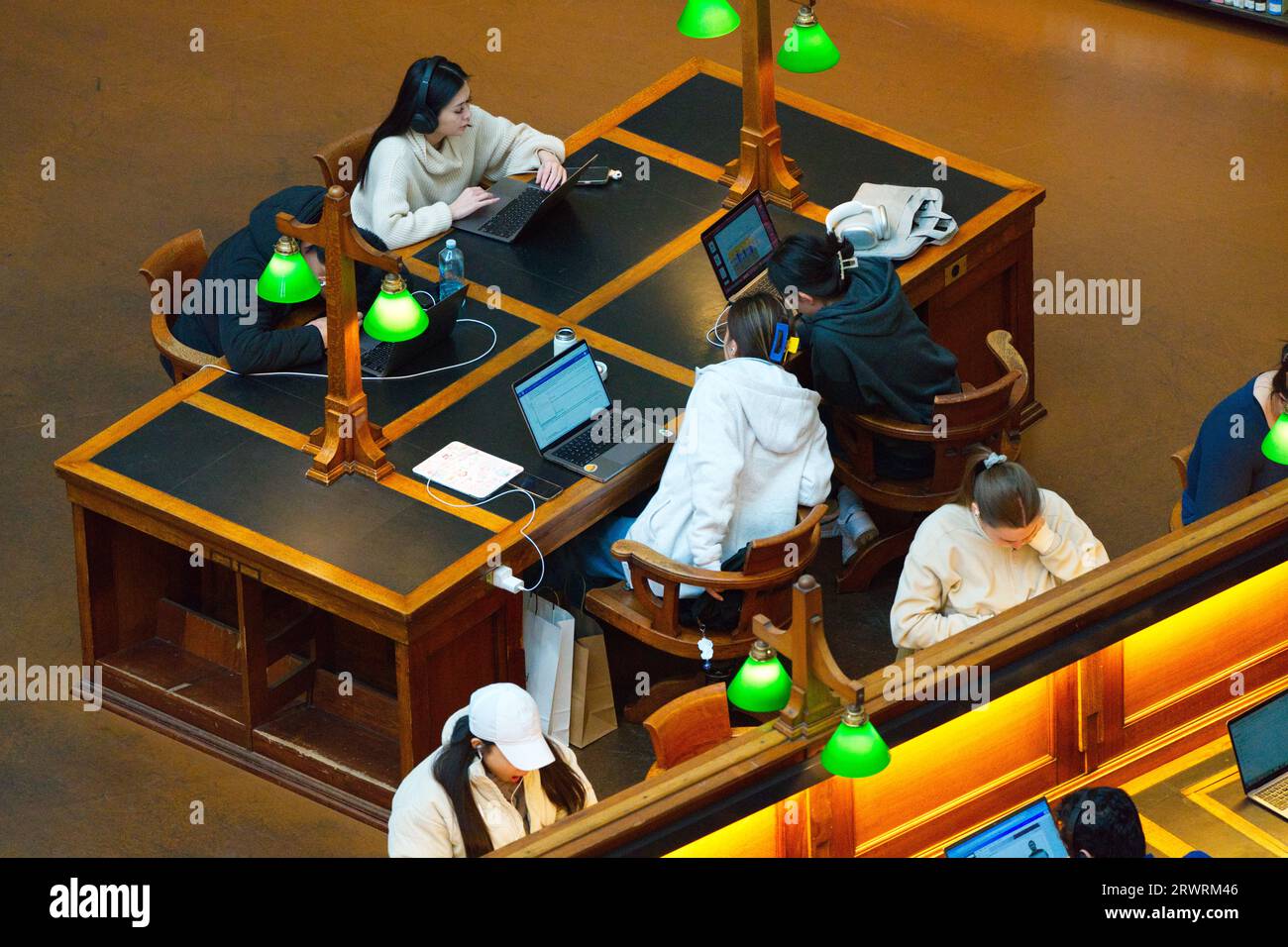 Menschen, die gemeinsam mit Computern und Laptops in einem ruhigen Raum in der Melbourne State Library, Victoria, Australien, studieren. Stockfoto