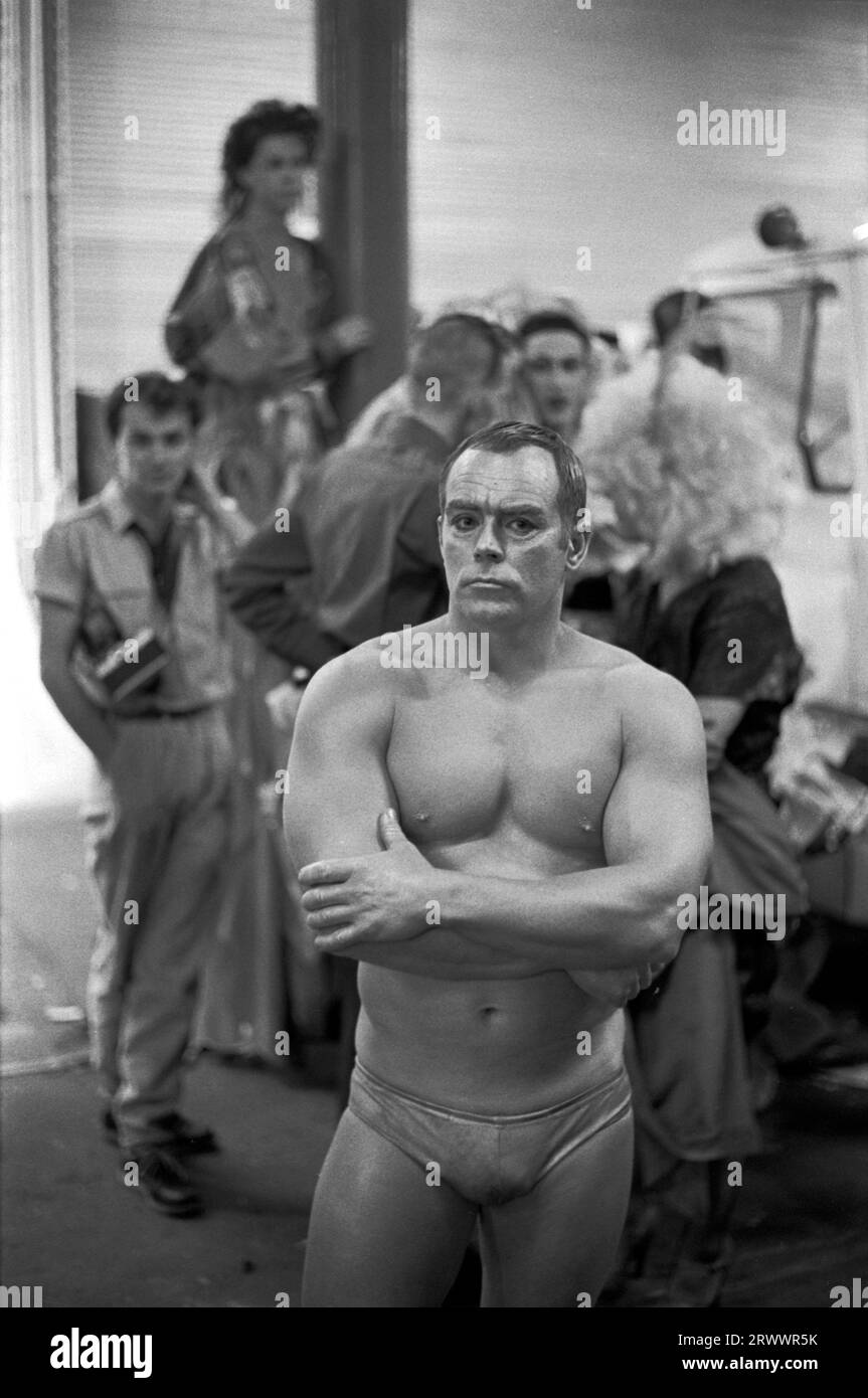 Muscle man hinter der Bühne zu Beginn des alternativen Miss World Schönheitswettbewerbs Olympia West London 1981 1980s UK HOMER SYKES Stockfoto