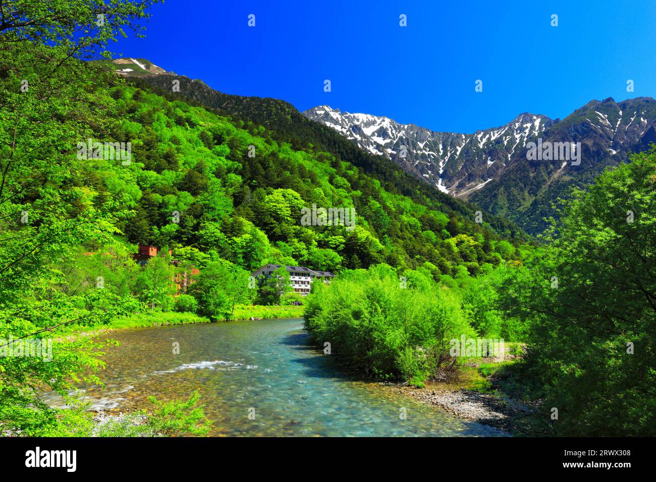 Klarer, klarer Azusa-Fluss und schneebedeckte Hotaka-Berggipfel in Kamikochi Stockfoto