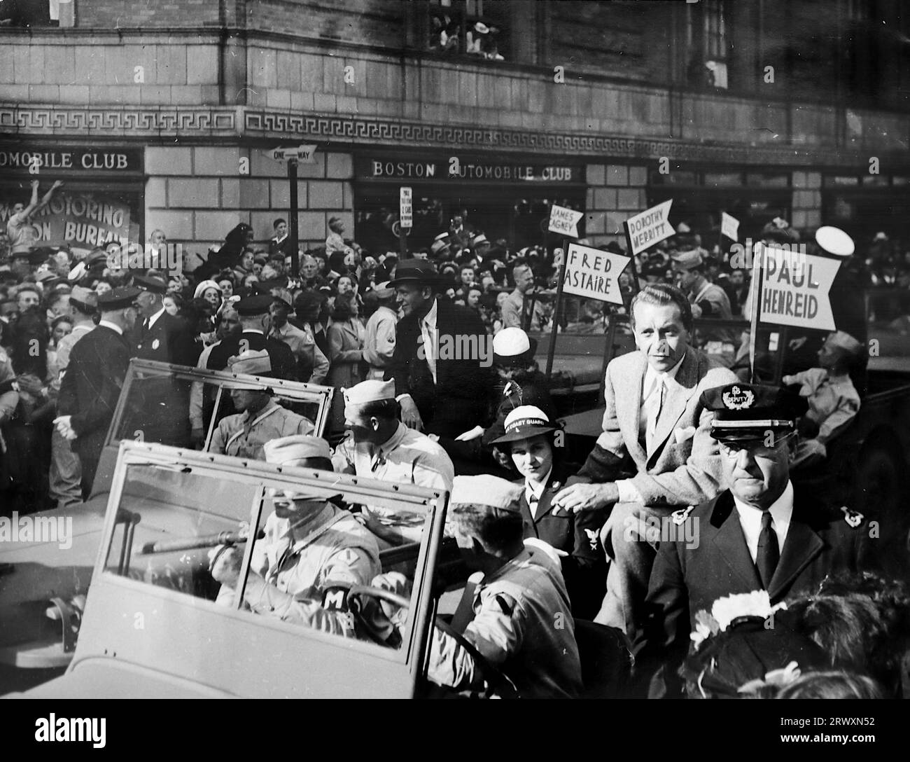 Parade in Boston mit Hilfe von Kriegsanleihen: Paul Henreid, Fred Astaire und andere in den Paradeautos. Seltenes Foto: Aus einer Sammlung eines unbekannten britischen Soldaten über die No. 1 Composite Demonstration, AA Battery, Tour durch die USA, vom 11. Juli 1943. Dies ist eines von mehr als hundert Bildern in der Sammlung, die im Durchschnitt etwa 4 x 3 Zoll groß waren. Stockfoto