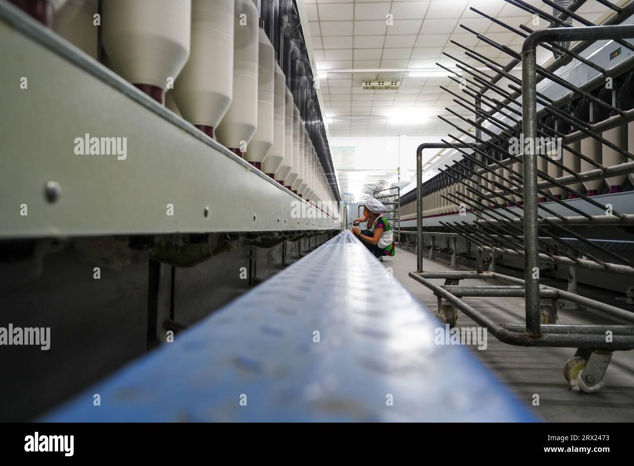 Luannan County, China - 5. September 2022: Arbeiter warten Spinnereien in einer Spinnerei. Stockfoto