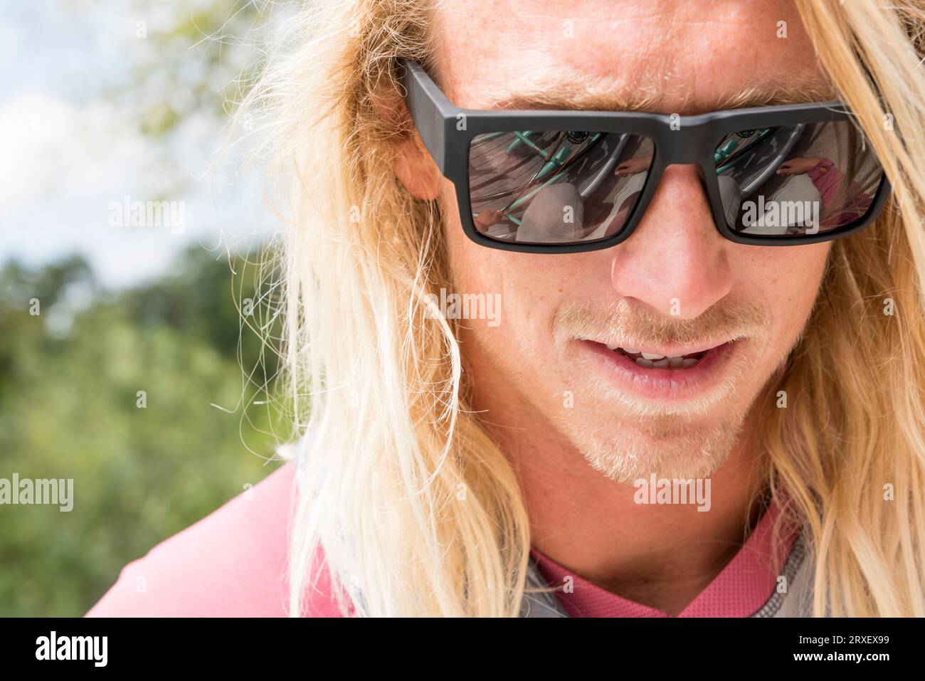 Porträt Eines Mannes Mit Langen Haaren, Der Eine Sonnenbrille Trägt Stockfoto