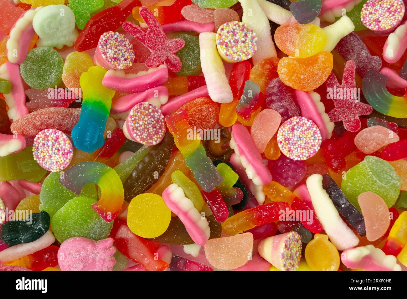 Kreativer Hintergrund aus gummiartigen Süßigkeiten. Farbenfrohe flache Lage. Gelee-Bonbons ästhetisch. Stockfoto