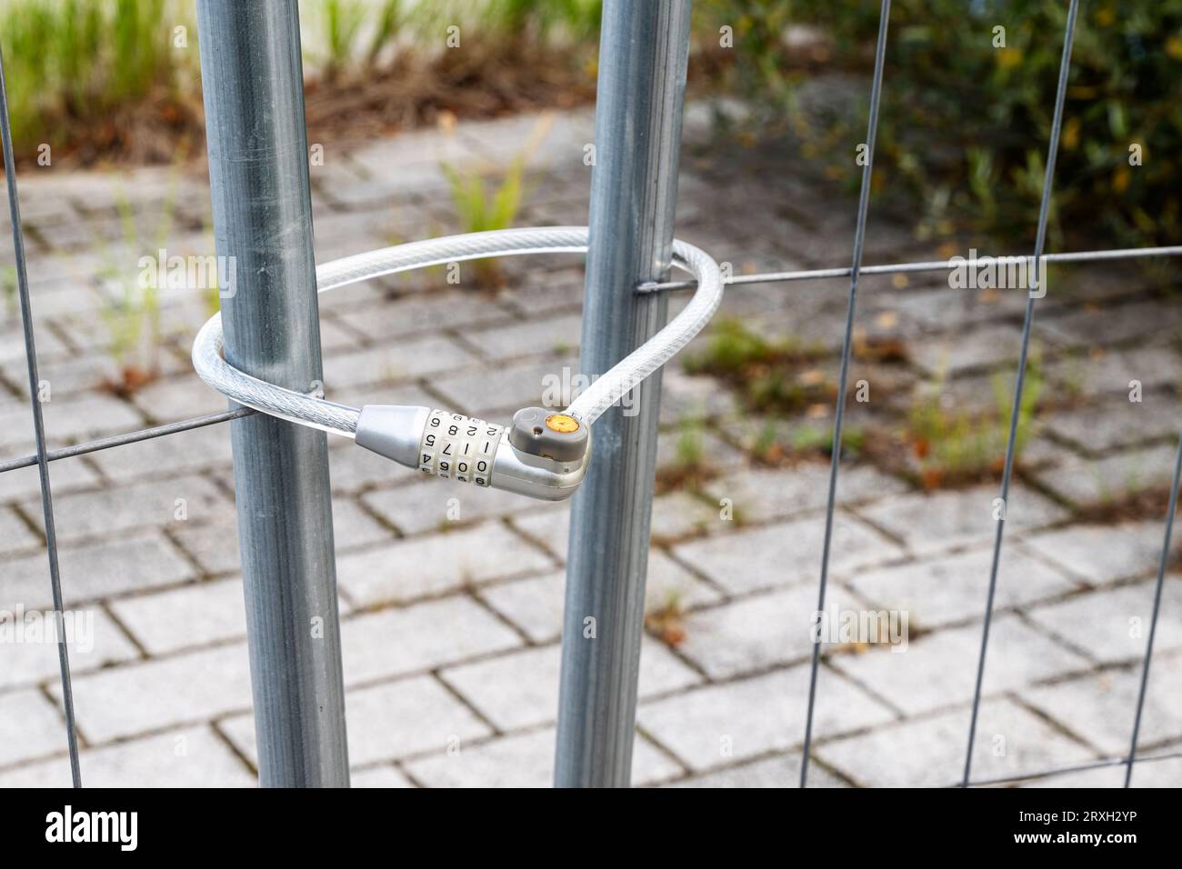 Ein Bauzaun wurde mit einem Fahrradschloss für Fahrräder verschlossen Stockfoto