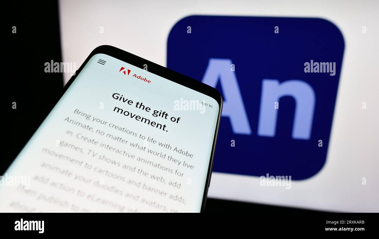 Smartphone mit Webseite der Computer-Animationssoftware Adobe Animate auf dem Bildschirm vor dem Firmenlogo. Konzentrieren Sie sich auf die obere linke Ecke des Telefondisplays. Stockfoto