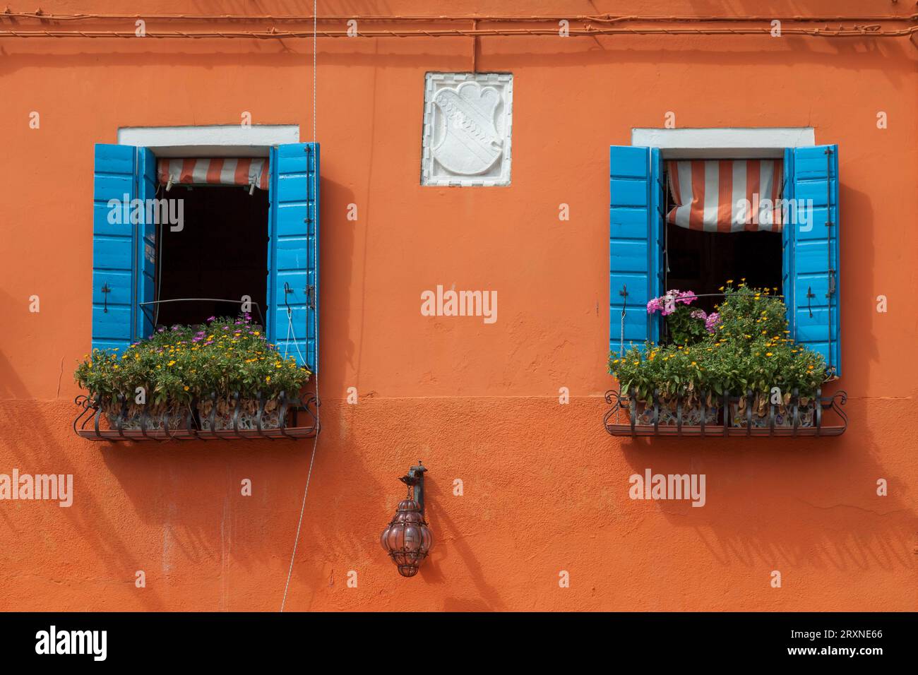 Orangefarbene Hausfassade mit zwei Fenstern, Burano, Venedig, Venetien, Italien Stockfoto