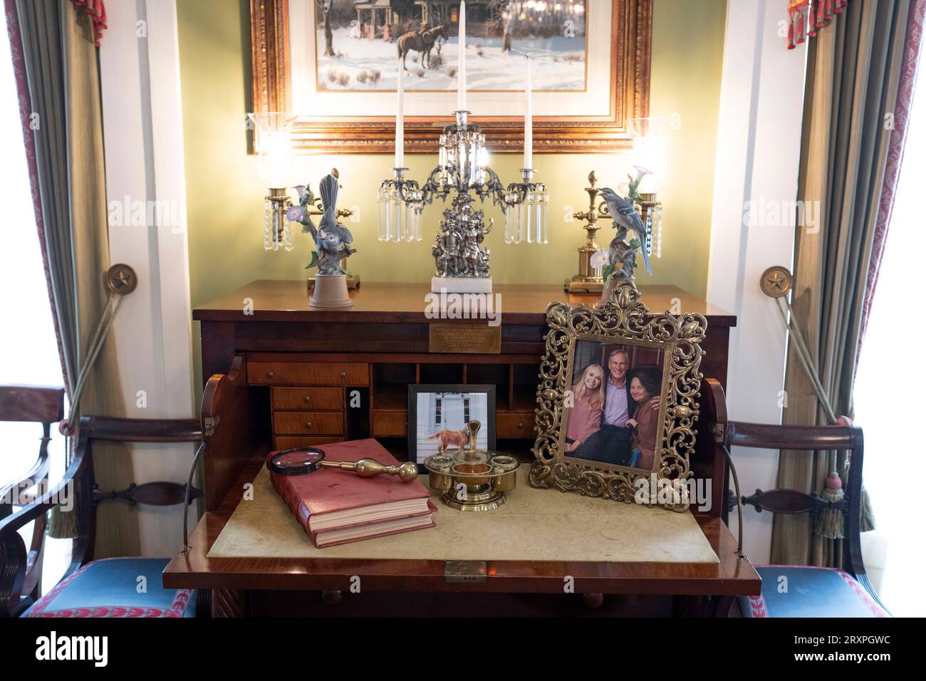 Ein Bild des derzeitigen Gouverneurs von Texas Greg Abbott, Ehefrau Cecilia. Und Tochter Audrey sitzt am 21. September 2023 auf einem Schreibtisch, umgeben von Antiquitäten und historischen Artefakten in einem Wohnzimmer im Governor's Mansion in Austin. ©Bob Daemmrich Stockfoto