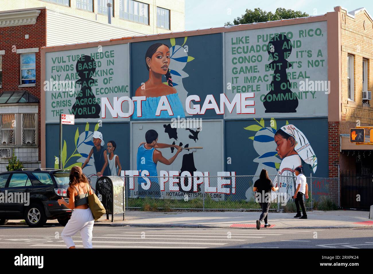 Ein NYC-Wandbild mit der Aufschrift „es ist kein Spiel, es sind Menschen!“ Verweis auf Geier-Hedgefonds, die sich wirtschaftlich instabile Nationen in Krisensituationen zunutze machen. Stockfoto