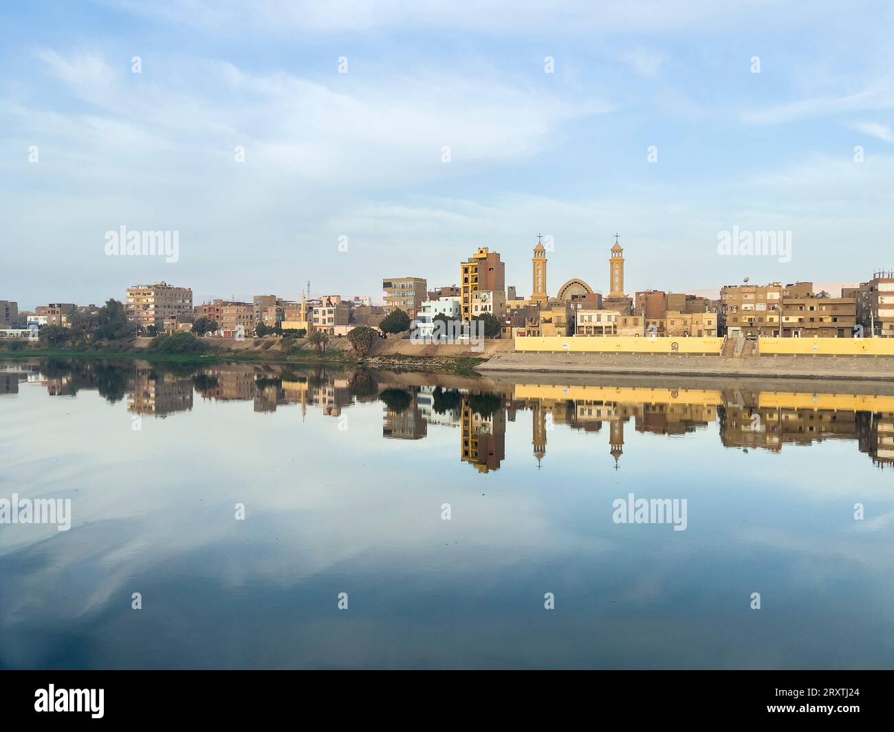 Blick auf Gebäude, die sich im Wasser am Nil spiegeln, Dendera, Ägypten, Nordafrika, Afrika Stockfoto Blick auf Gebäude, die sich im Wasser am Nil spiegeln, Dendera, Ägypten, Nordafrika, Afrika Stockfoto