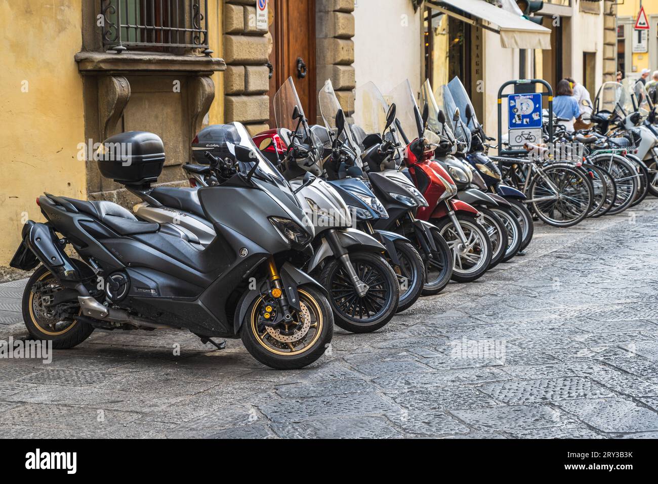 Florenz, Italien – 13. September 2023. Eine horizontale Aufnahme von vielen Motorrädern, die an einer Seitenstraße in Florenz, Italien, geparkt sind. Stockfoto