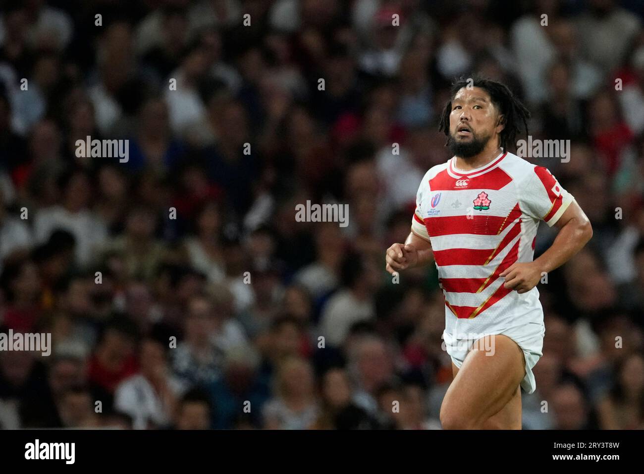 Japan's Shota Horie leaves the field after being shown a yellow card