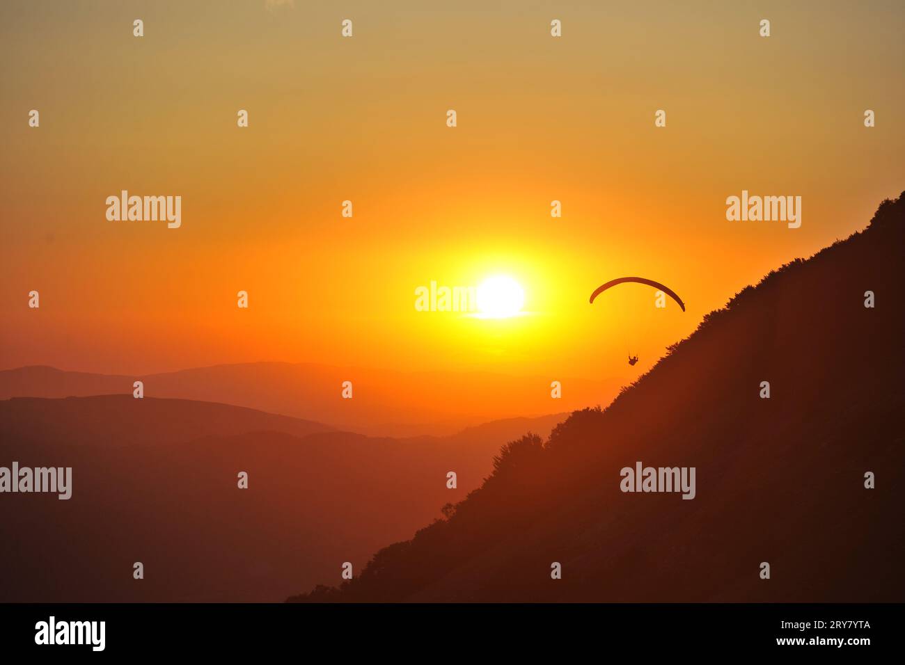 Gleitschirmfliegen in den Sonnenuntergang, Alpen, Österreich Stockfoto