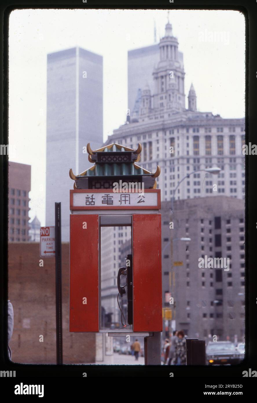 Ein Foto aus dem Jahr 1978 von einer öffentlichen Telefonkabine im Freien, geformt wie eine Pagode und mit chinesischer Schrift. Das Rathaus, das MCC-Gefängnis und die Twin Towers sind im Hintergrund. Stockfoto