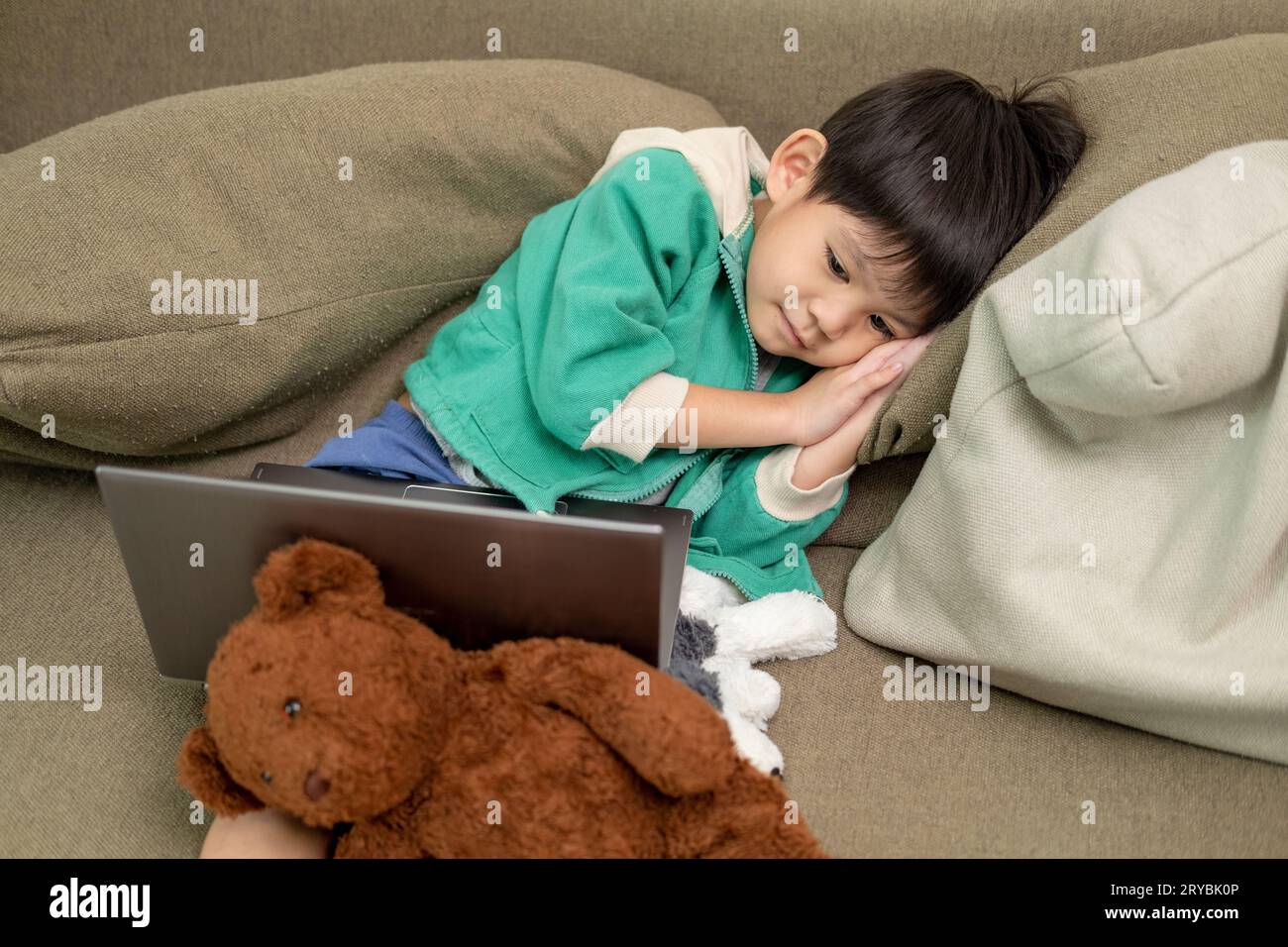 Asiatischer Junge schläft, während er online auf dem Laptop lernt Stockfoto