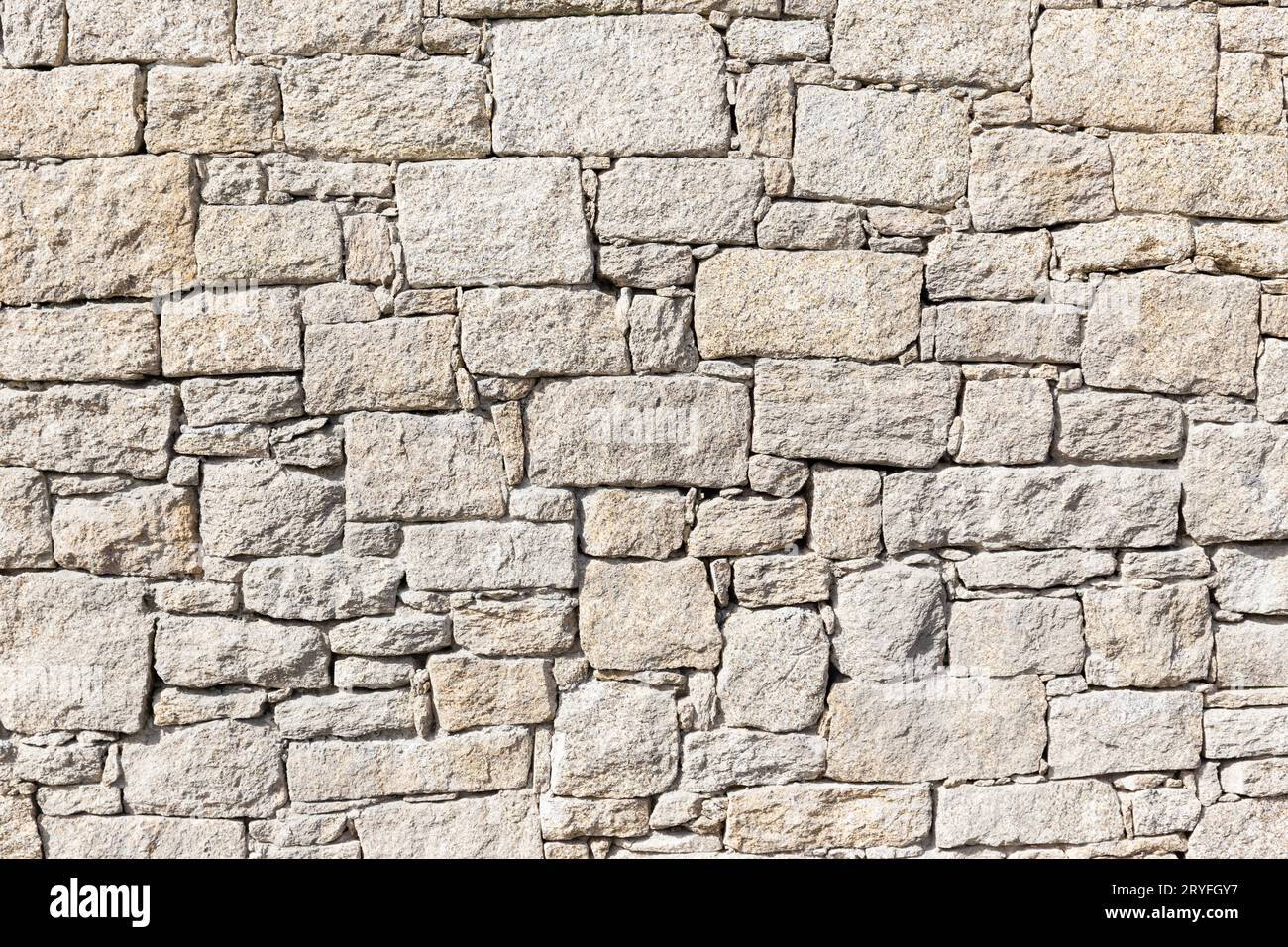 Granit Stein Wand Hintergrundstruktur. Trockenmauerwerk Stockfoto