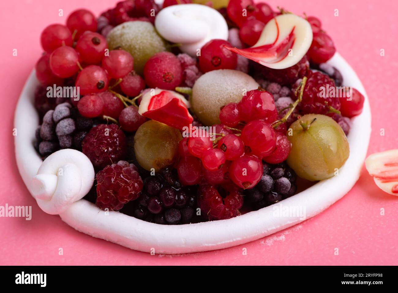 Nahaufnahme eines leckeren rosafarbenen Mousse-Tortes, dekoriert mit einigen Beeren. Stockfoto