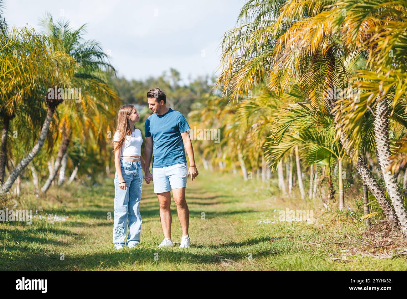 Familie von Tochter und Vater, die Spaß unter Palmen im Urlaub haben. Familienurlaub Stockfoto