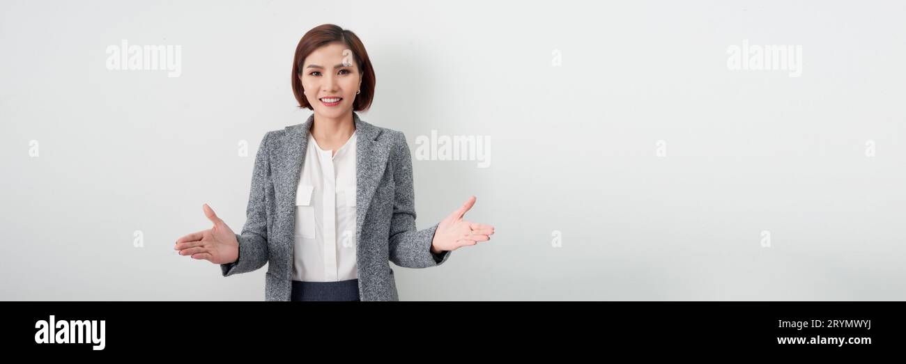 Banner des lächelnden Glücklichen schönen jungen asiatischen Geschäftsfrau in zwangloser Kleidung, die offene Handgesten macht Stockfoto