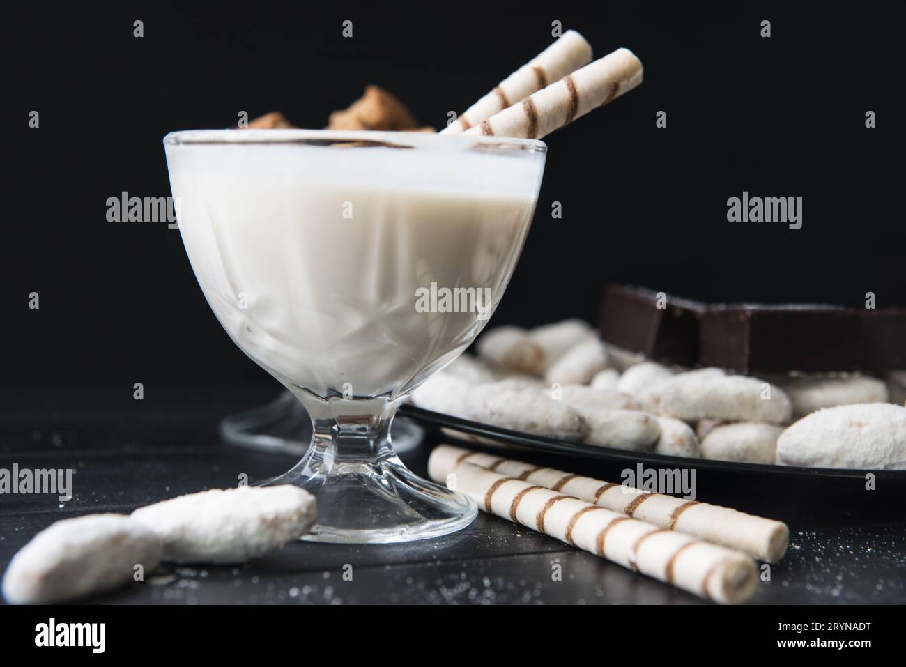Süßigkeiten, Strohhalme in der Creme, Kekse und Süßigkeiten auf dem Tisch Stockfoto
