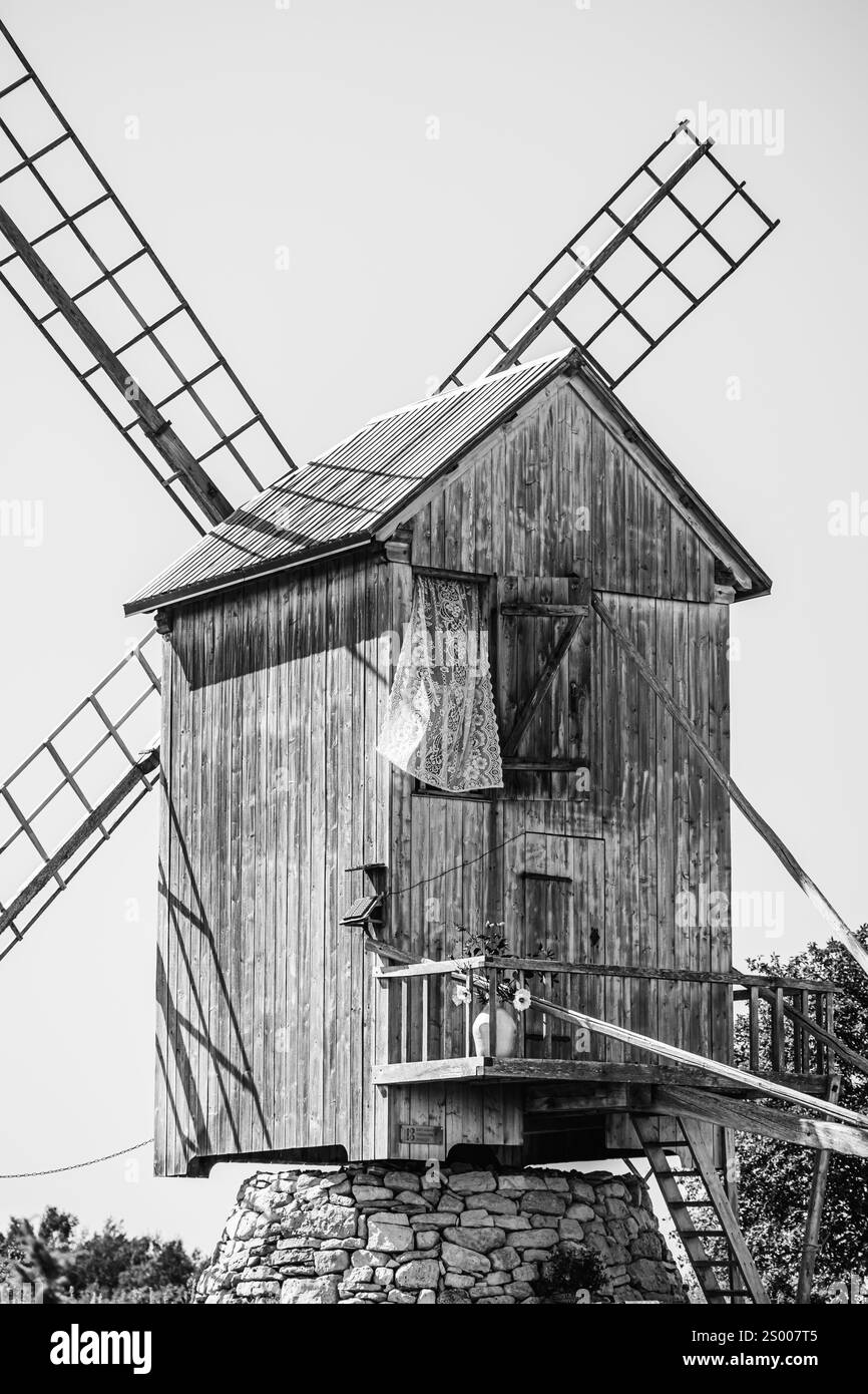 Hölzerne Windmühle auf einer Steinmauer Stockfoto