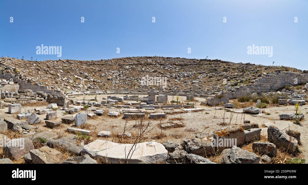 Ruinen eines antiken Amphitheaters umgeben von natürlichen Hügeln unter klarem Himmel, Delos, Griechenland Stockfoto