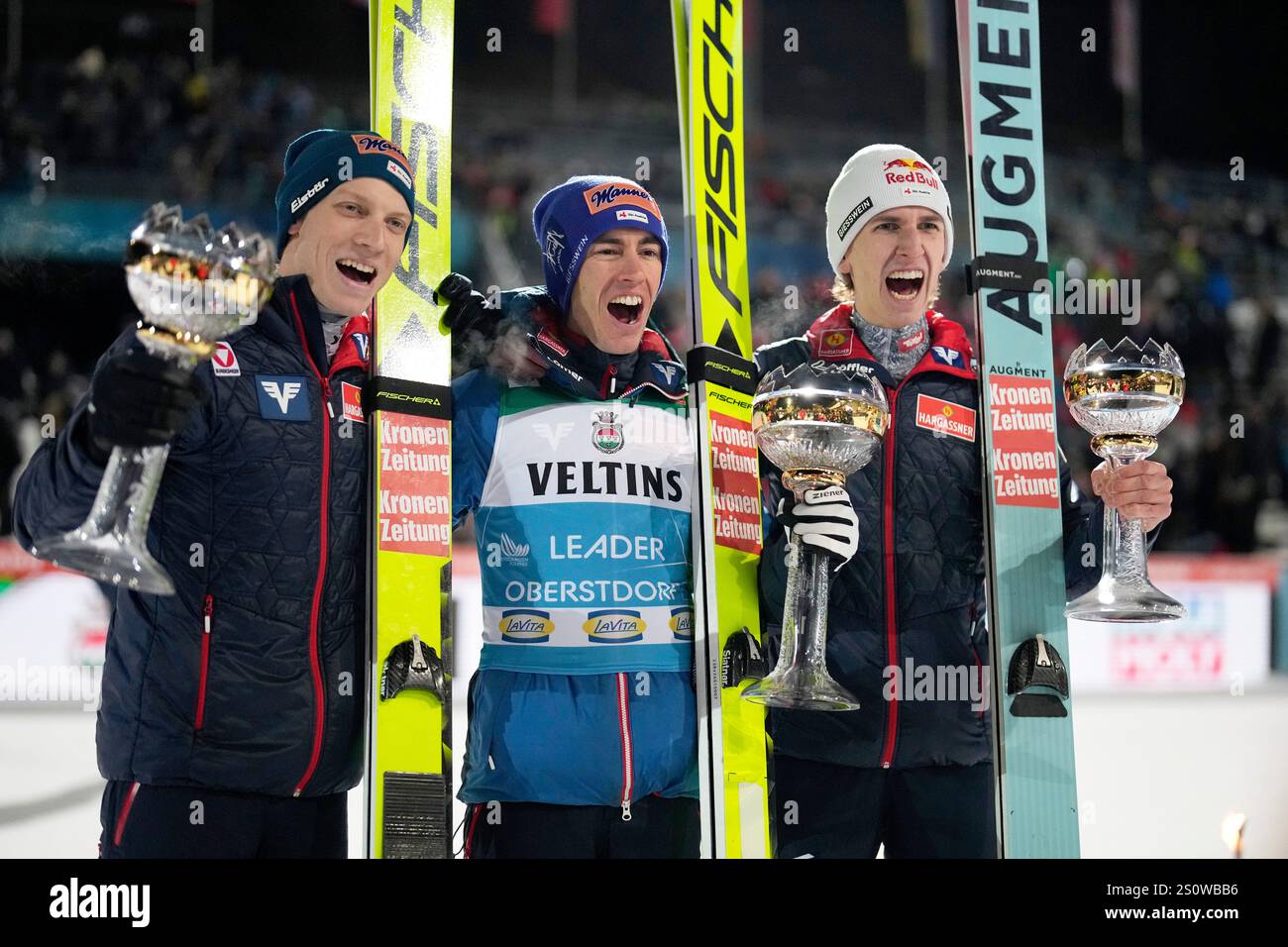 Second placed Jan Hoerl, winner Stefan Kraft and third placed Daniel Tschofenig, from left, all three of Austria, pose with their trophies after the first stage of the 73rd Four Hills ski jumping tournament in Oberstdorf, Germany, Sunday, Dec. 29, 2024. (AP Photo/Matthias Schrader) Stockfoto