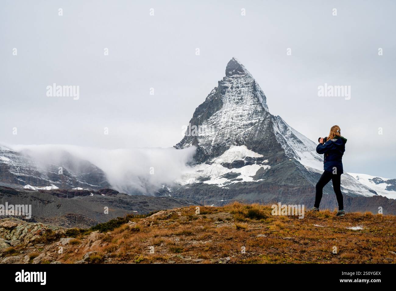 Eine Fotografin fotografiert das Matterhorn in den Schweizer Alpen Stockfoto