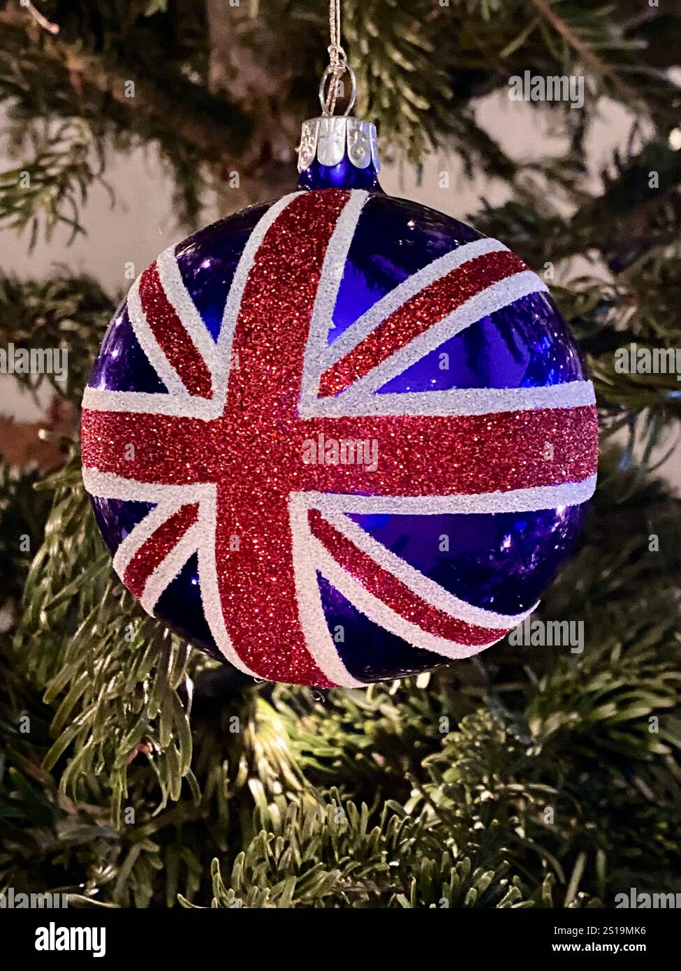 Festliches Weihnachtsbaumschmuck mit Union Jack Design in festlicher Atmosphäre - Smartphone-aufgenommenes Stockfoto