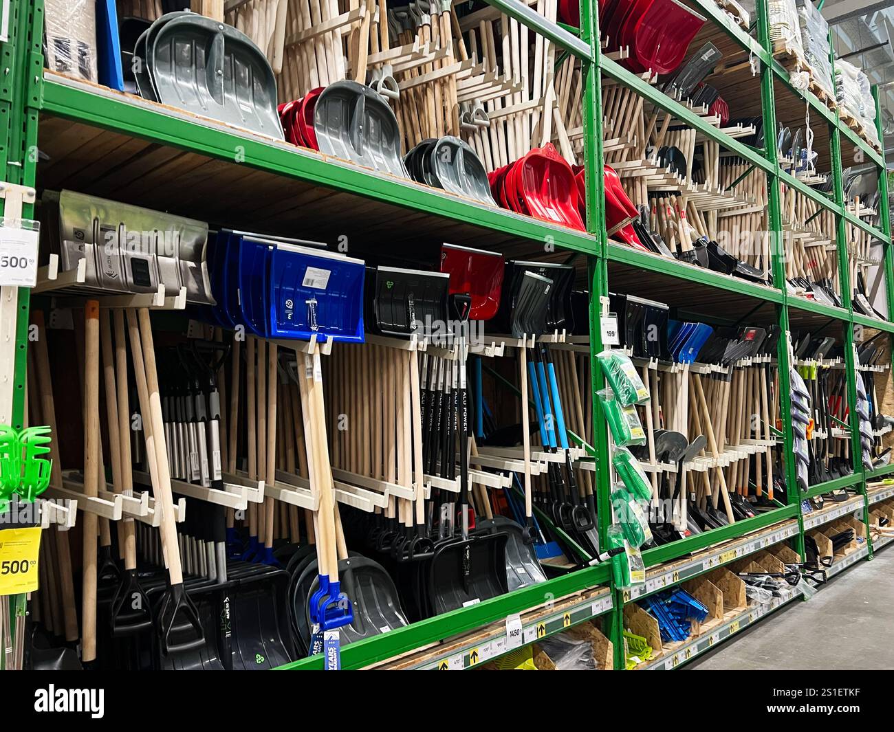 Kiew, Ukraine - 03. Januar 2025: Eine große Auswahl an bunten Schneeschaufeln, die in Regalen in einem Ladengang organisiert sind und Werkzeuge für Winterschnee präsentieren Stockfoto