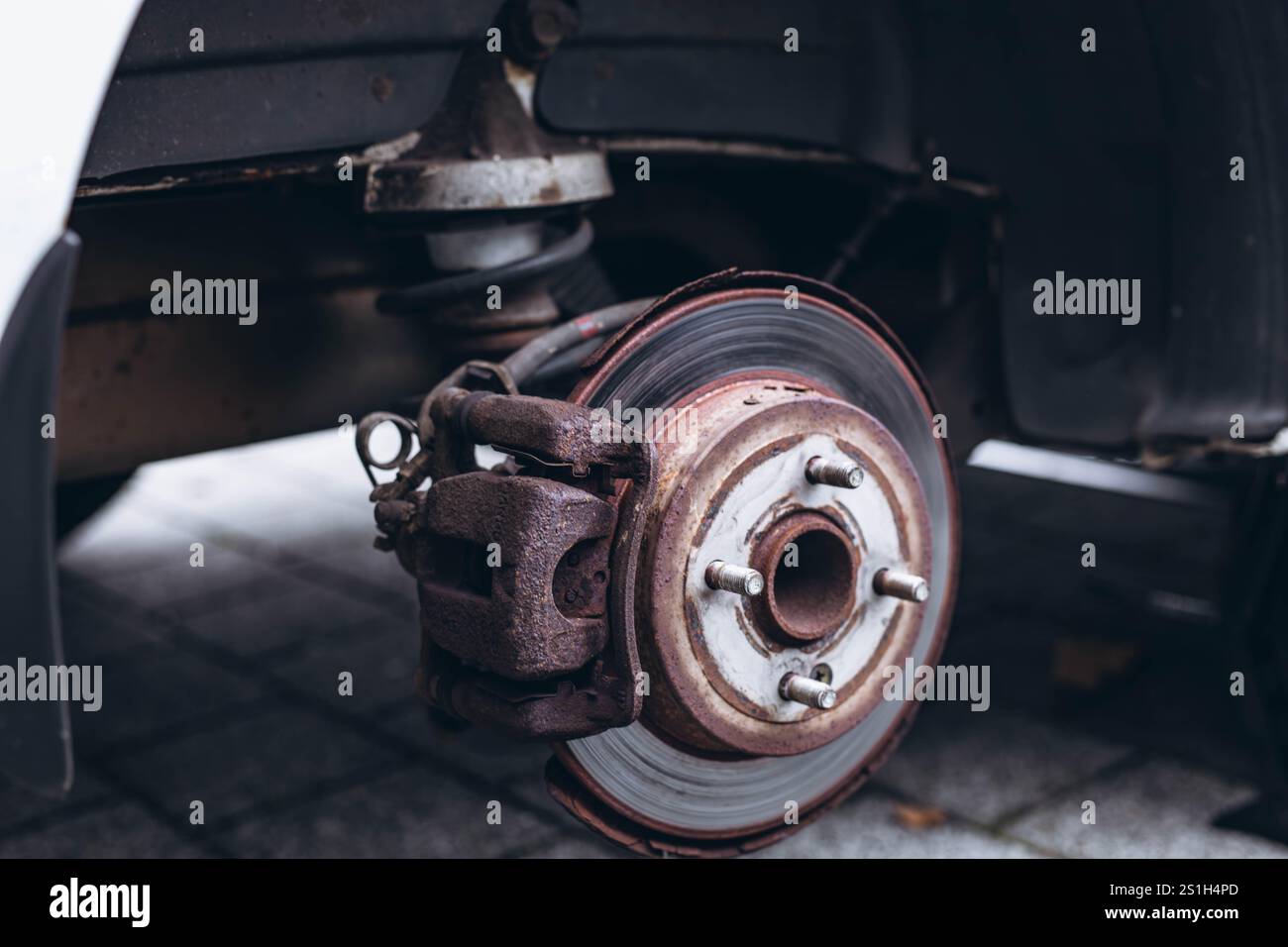 Teil eines Fahrzeugs ohne Rad, das für den Reifenwechsel während einer Straßenreparatur angehoben wurde. Hochwertige Fotos Stockfoto