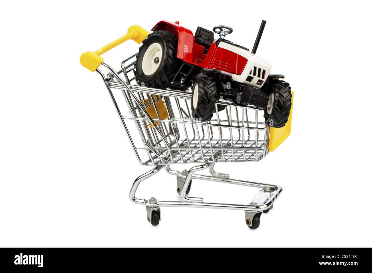 Ein Traktor in einem Einkaufswagen symbolisiert den Kauf eines neuen landwirtschaftlichen Geräts Stockfoto