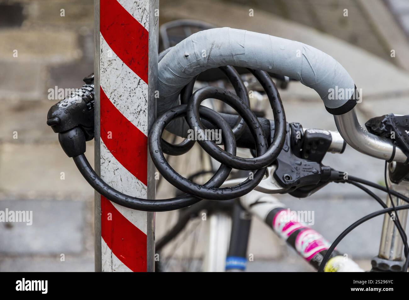 Ein Fahrrad wurde an einer Stange befestigt, um es vor Diebstahl zu schützen. Fahrradschloss als Diebstahlsicherung Österreich Stockfoto