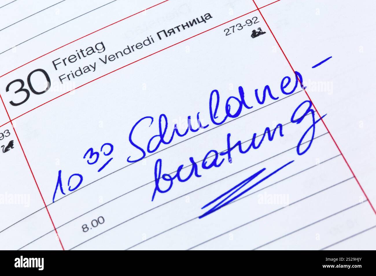 Schuldenberatung in einem Kalender. Symbolisches Foto für Armut und persönlichen Bankrott Stockfoto