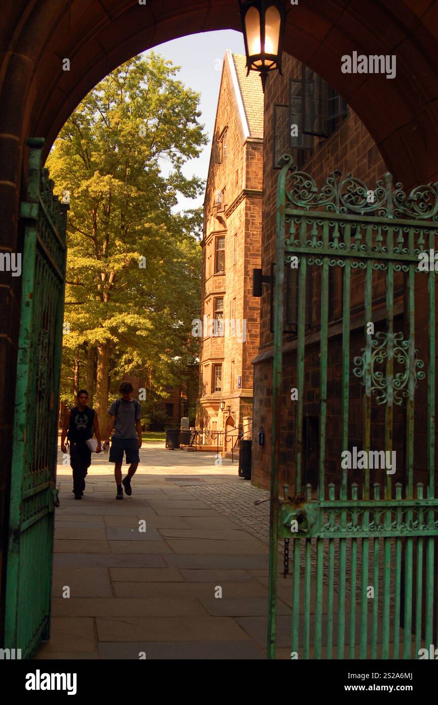 Zwei Studenten gehen durch ein offenes Tor zum Hauptcampus der yale University in New Haven, Connecticut Stockfoto