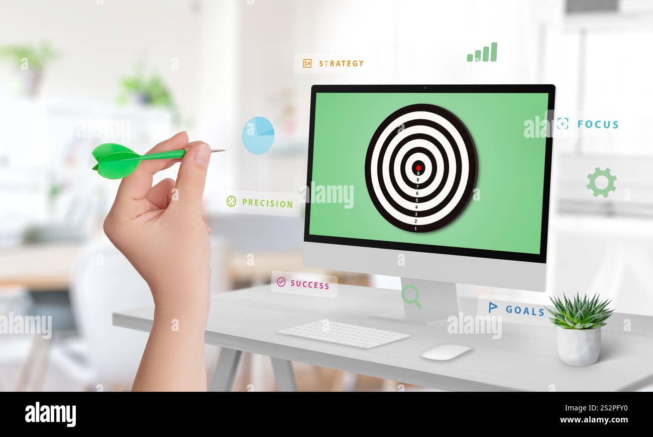 Hand, die auf ein Display mit einem Ziel zielt, das von fließenden Wörtern wie Zielen, Strategie, Erfolg, Präzision und Fokus umgeben ist, symbolisieren effektiver Märkte Stockfoto