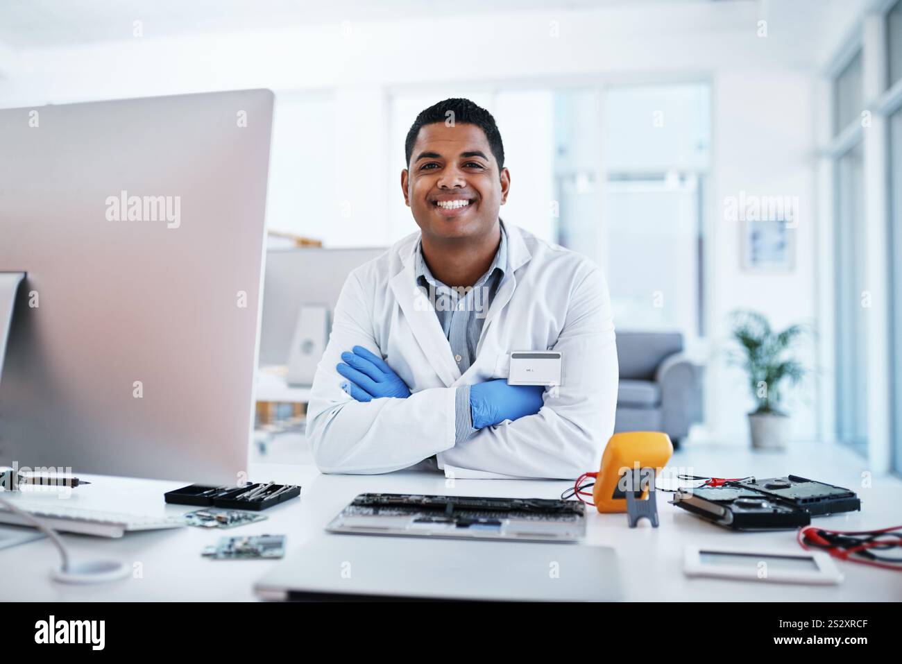 Mann, Portrait und Computeringenieur, der im Büro repariert, Tastaturwartung und Upgradesystem durchgeführt wird. Männliche Person, Arme gekreuzt und Installation von Stockfoto