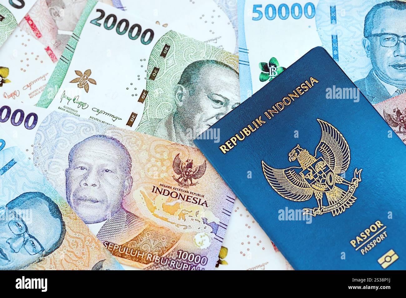 Indonesien-Pass und viele indonesische Rupiah-Geldscheine aus nächster Nähe. Indonesien Pass und viele indonesische Rupiah Geldscheine Stockfoto